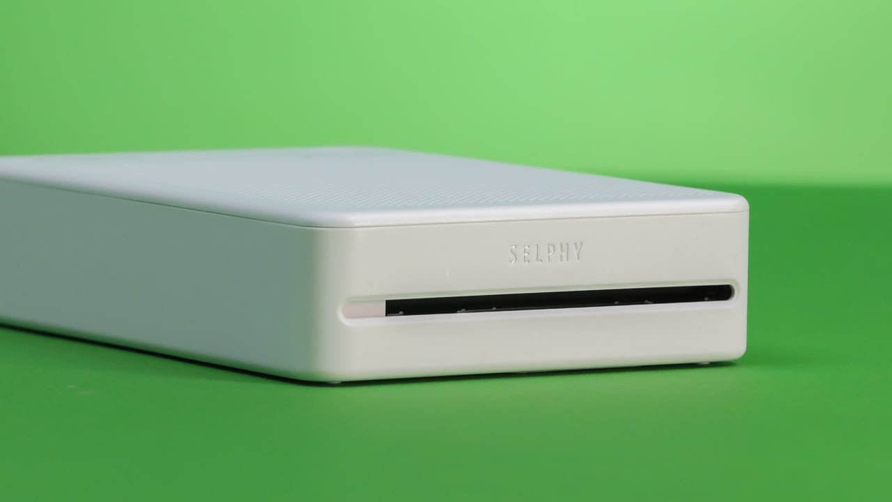 Canon Selphy snapshot printer on green background