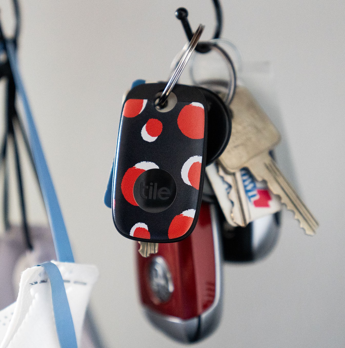 Colorful Tile Pro hanging from a key ring on a hook