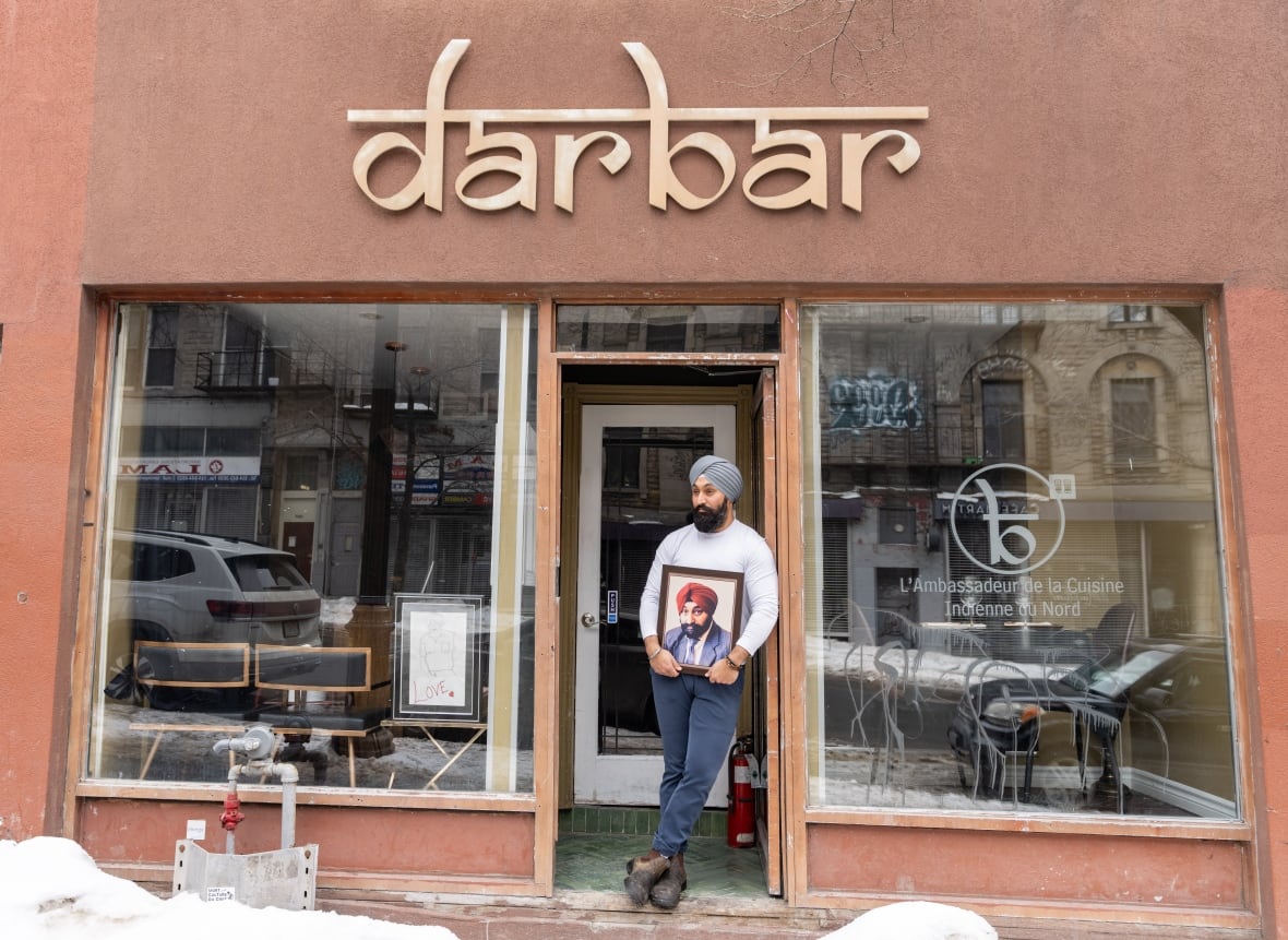 Simar Singh Anand, who calls himself a steward of legacy for his father Gurinder (Babu) Singh Anandm holds his father's photo at his restaurant in Montreal on Tuesday, March 4, 2025.